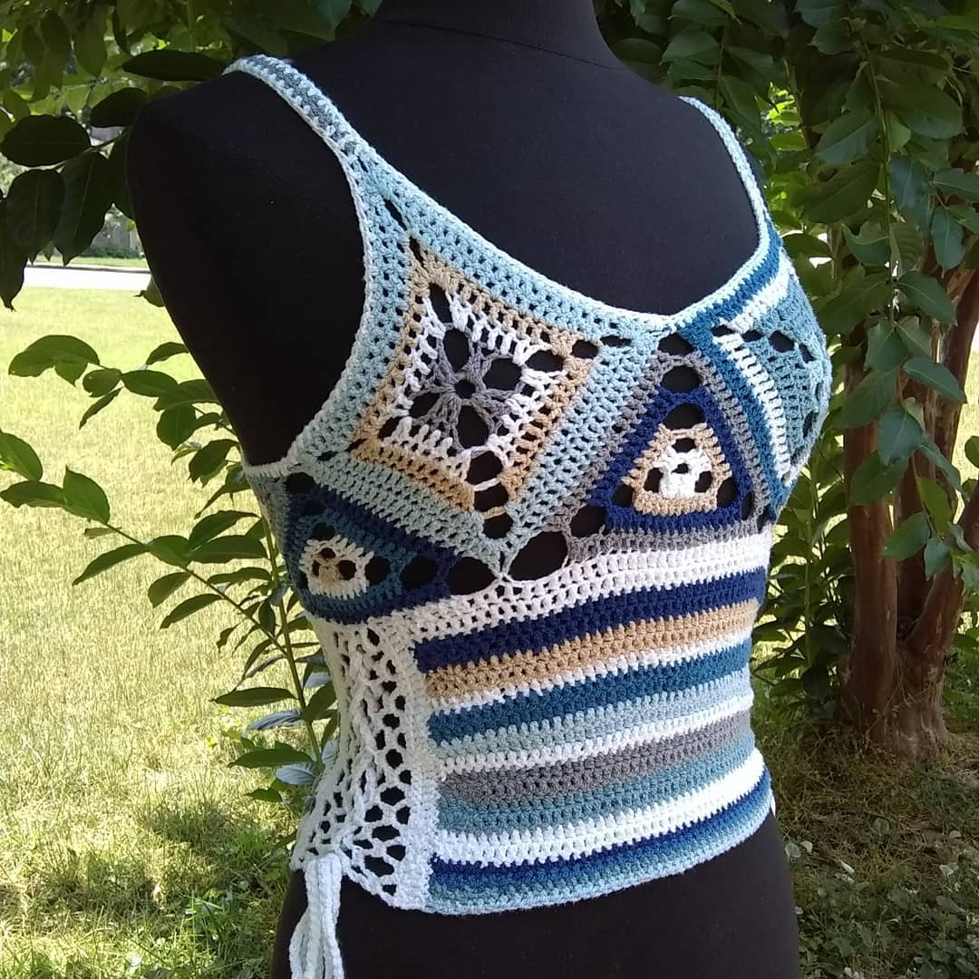 Donna Bleu Tank Top – Handmade by Pinkjoy Crochets. Made with Cotton Elastic yarn in white, tan, gray and various shades of blue and embellished with glass beads. Size Small. $250.

Get it here. 
https://pinkjoycrochets.com/boutique/lines/summer/donna-bleu-tank/